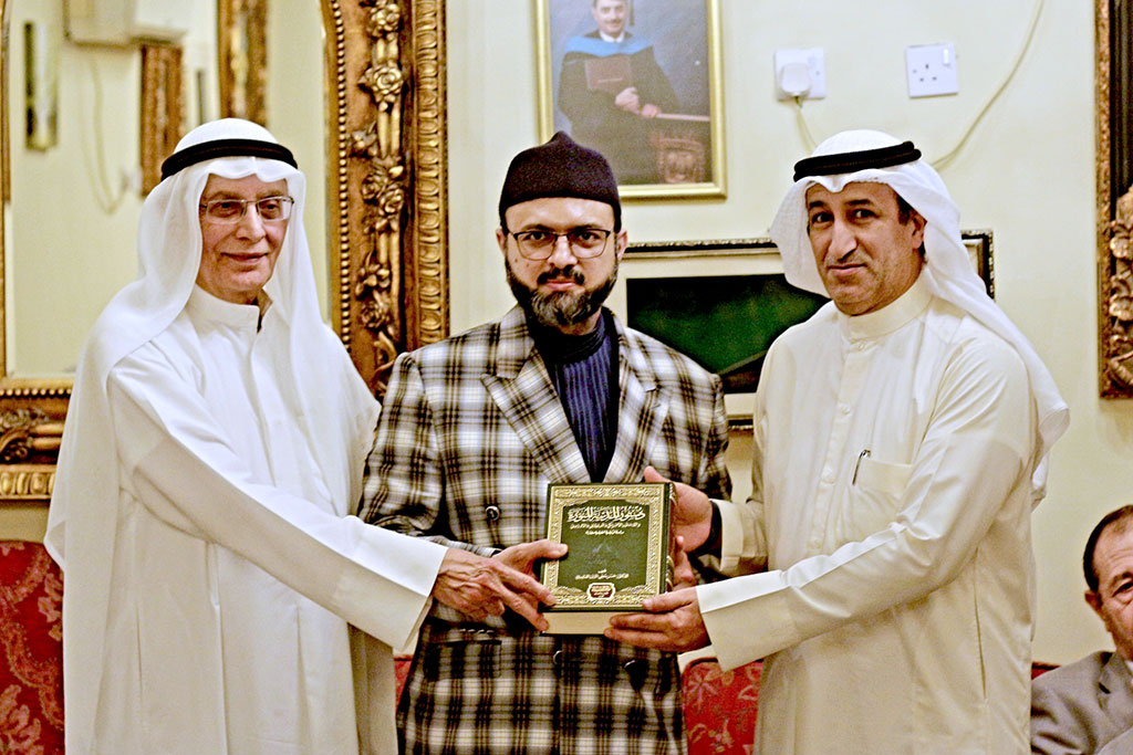 Dr Hassan Qadri is presenting the Hadith Encyclopedia to the distinguished guest