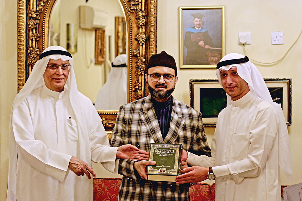 Dr Hassan Qadri is presenting the Hadith Encyclopedia to the distinguished guest